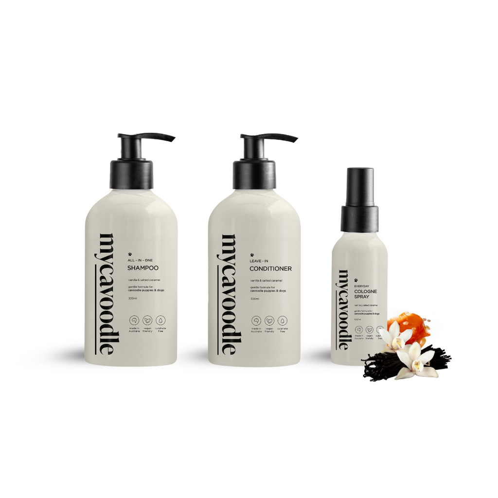Three bottles labelled as shampoo, conditioner, and cologne, intended for dog grooming in Vanilla and Salted Caramel Scent