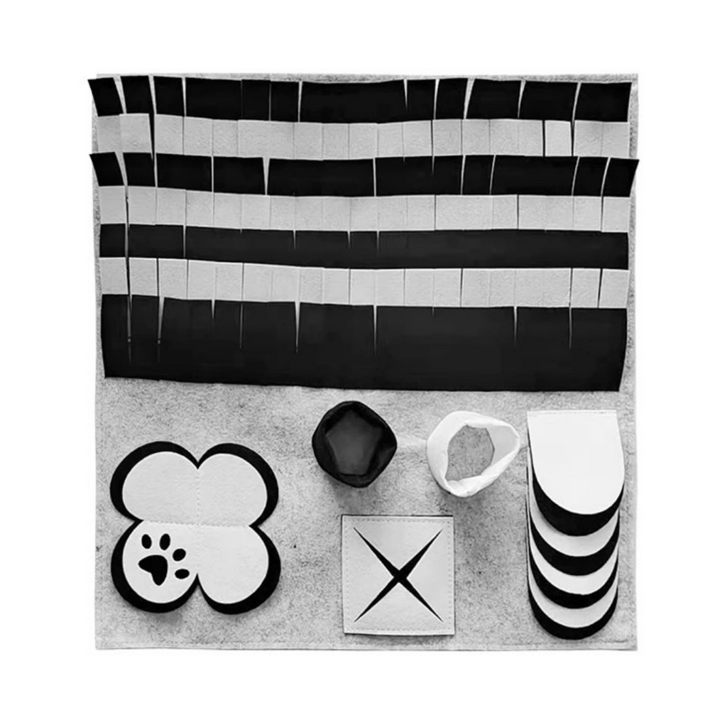 A black, grey, and white snuffle mat with textured sections designed for cavoodles to search for treats.